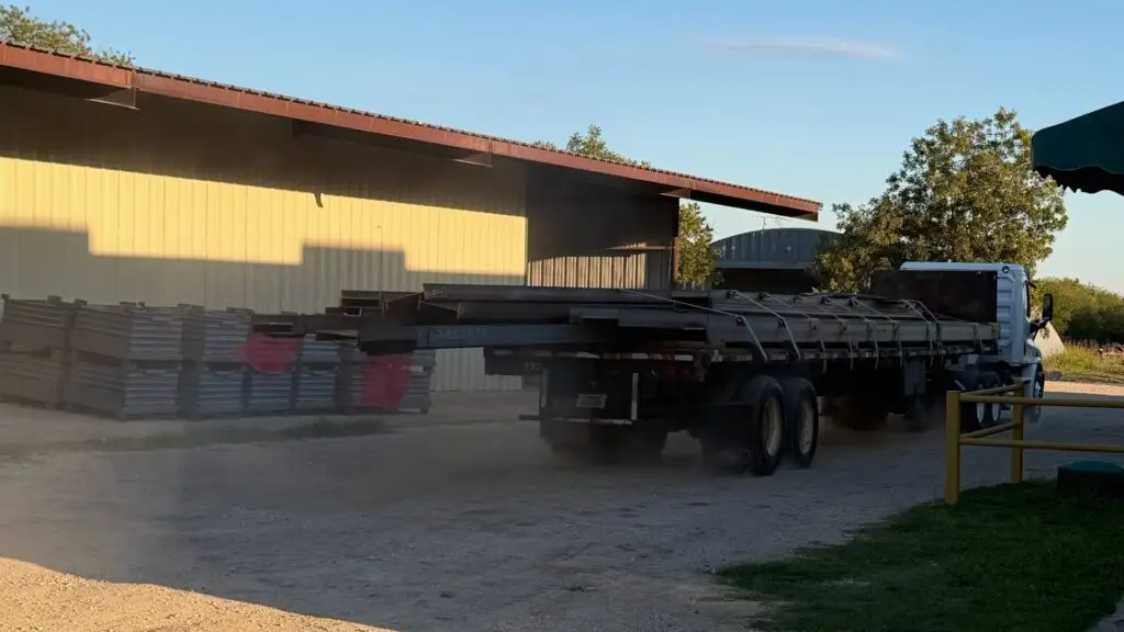 Flatbed loaded with fabricated structural steel leaving the Heartland Steel yard in Woodway, TX